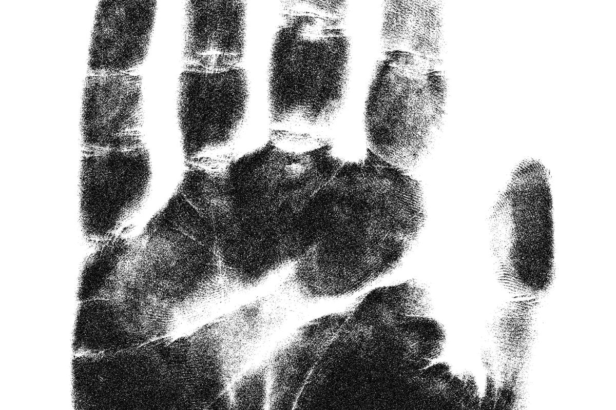 Black and white photo of a hand print — fingerprint background check